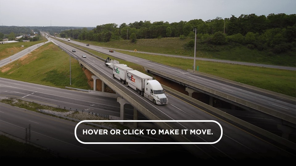 Drone footage of a FedEx truck zooming down the highway.