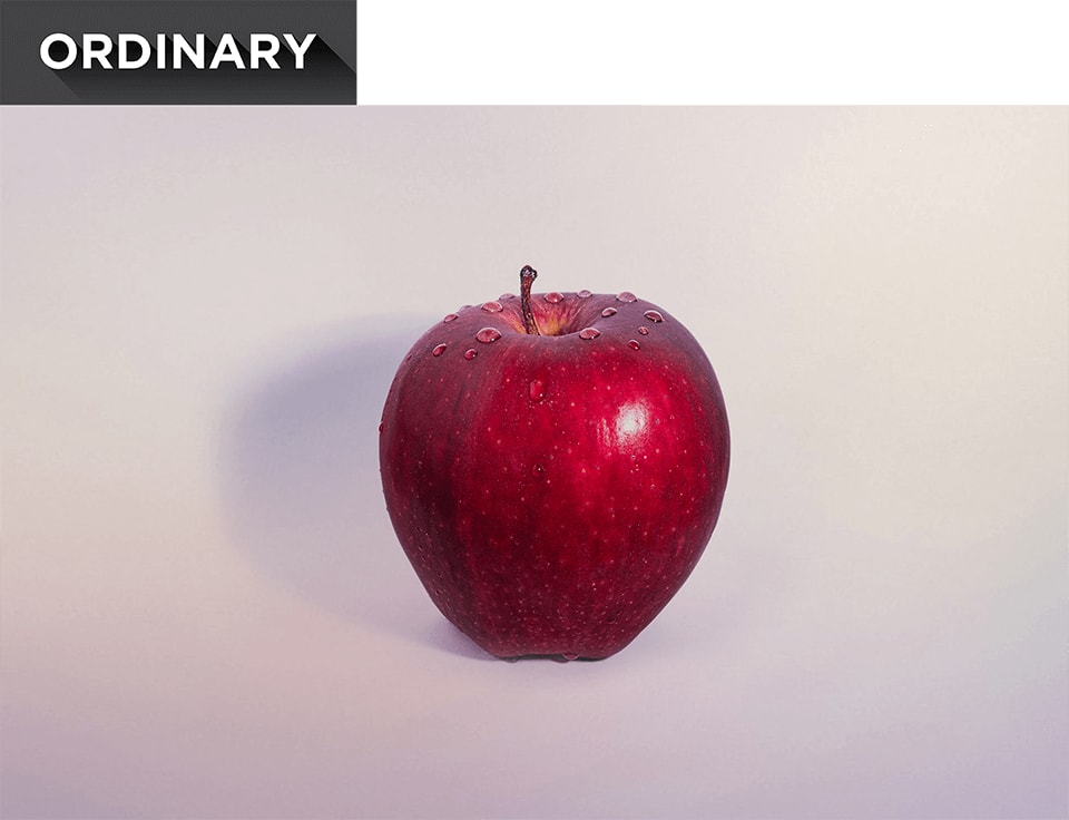 A red apple with water droplets on top.