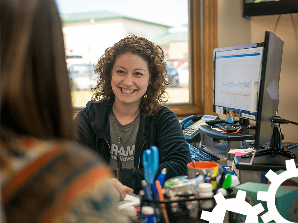 Penney smiling at her desk.