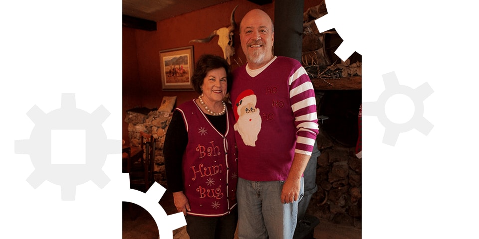 Todd and Julie Ramsey wearing ugly Christmas sweaters.