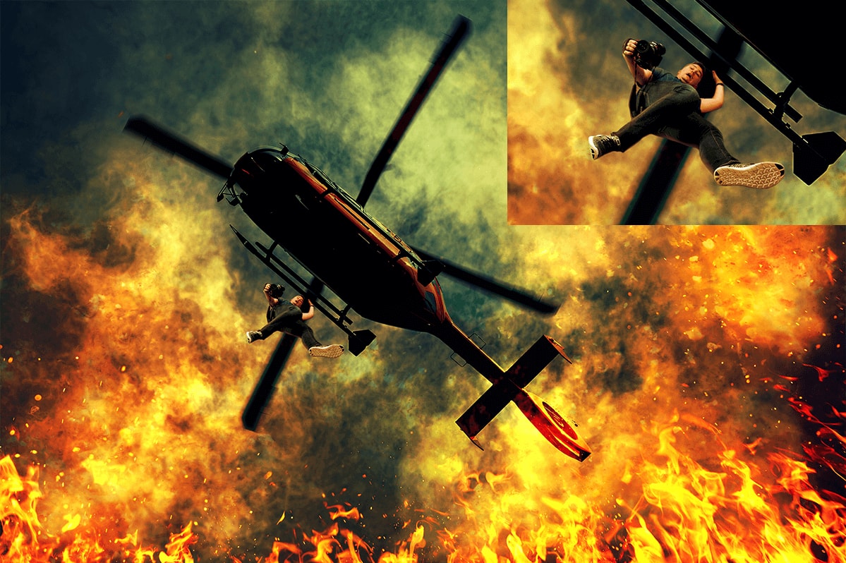 Dylan hanging from a helicopter, getting a picture inside the top of a volcano.