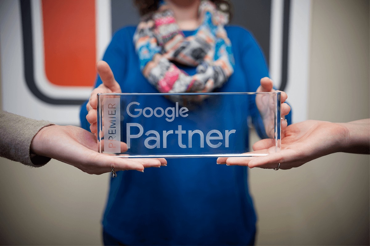 Close-up of the Google Premier Partner desk plaque.