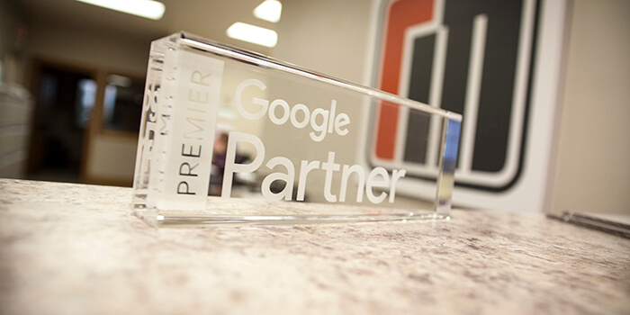 Desk plaque indicating Ramsey MediaWorks is a Premier Google Partner.