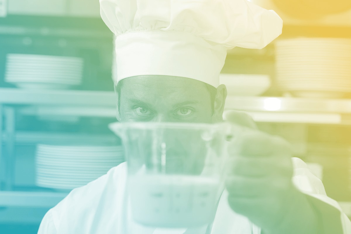 A chef checking the measurements of an ingredient.