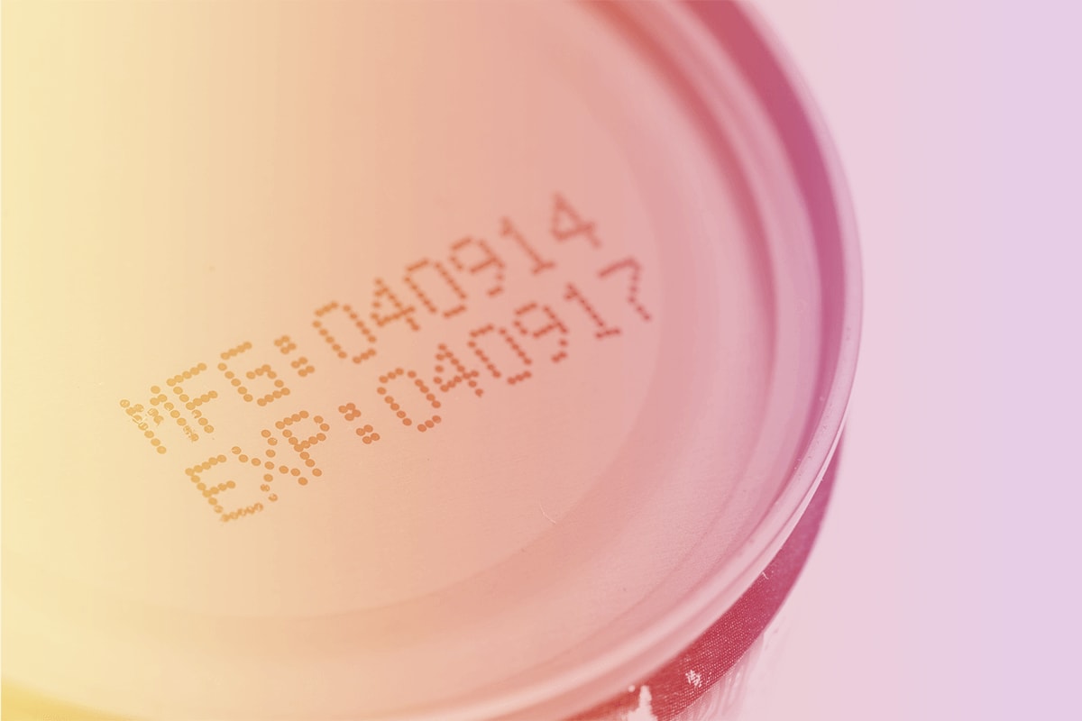 Labels on a can showing the manufacturing date and expiration date.