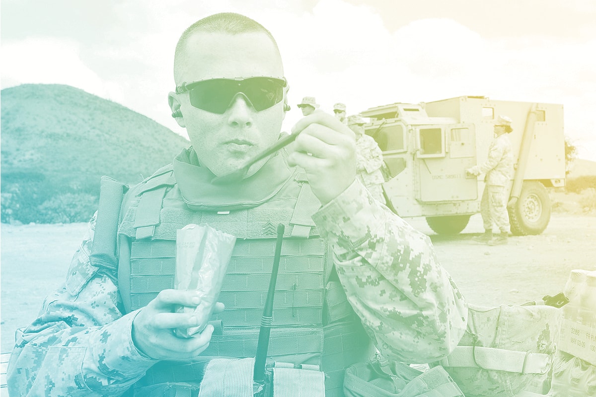 A soldier eating in uniform.